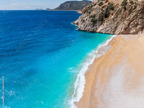 An aerial view of Kaputaş Beach, Kalkan, Turkey, showcasing the turquoise waters of the Mediterranean Sea and the scenic coastal town.