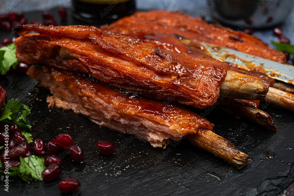 Vegan rack of  bbq ribs made with gluten and lemongrass stalks, on slate platter, stylish set up