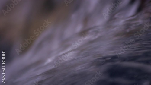 The power of water. Close up of a powerful and rapid crystal clear water.  Pure river flowing through the forest. Mountain water. Wild splash in the outdoor. 