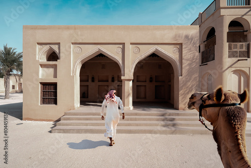 Arabic Man walking to House photo