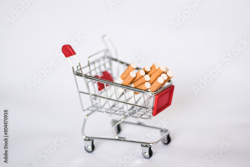 Cigarettes in carts, production, costs, product exports and No smoking concept.