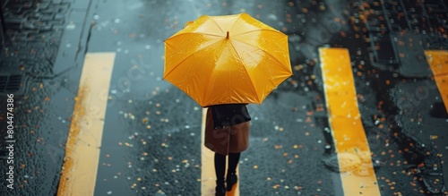 Person Walking Down Street With Yellow Umbrella