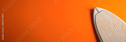 Bold surfboard traction pad web banner. Orange background with surfboard traction pad on the right side.