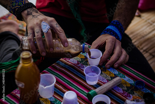 Sao Paulo, SP, Brazil - December 16 2023: Person serving doses of Ayahuasca details.