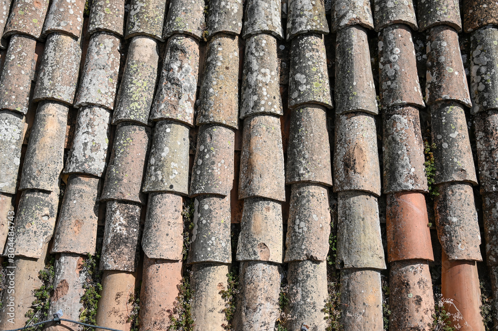 Old roof tiles on the roof on house. Texture of stone bricks, close up. Old roof tiles on the roof on house. Texture of stone bricks, close up.
