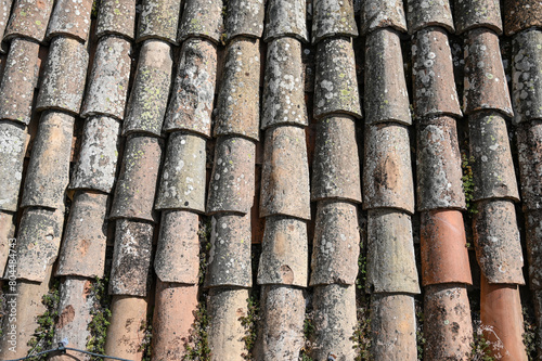 Old roof tiles on the roof on house. Texture of stone bricks, close up.   © Ajdin Kamber