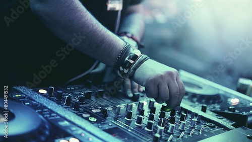 Dynamic DJ Set: Closeup of Unrecognizable DJ Mixing Tracks with CD Players and 4-Channel Mixer at Dance Party (4K image)