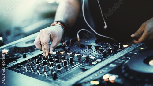 Dynamic DJ Set: Closeup of Unrecognizable DJ Mixing Tracks with CD Players and 4-Channel Mixer at Dance Party (4K image) photo