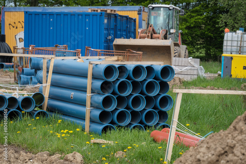 there are many blue pipes on a large construction site