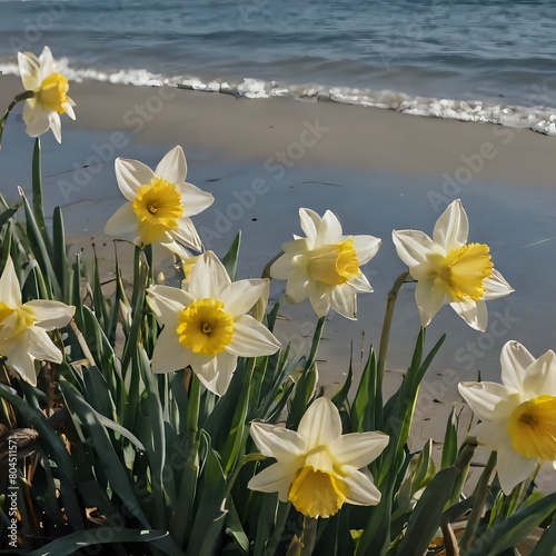 yellow and white flowers are growing on the beach near the water