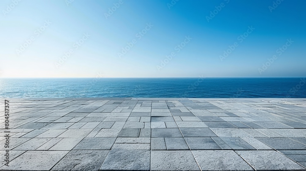   A panoramic perspective of the ocean from atop a building, backdropped by a blue sky