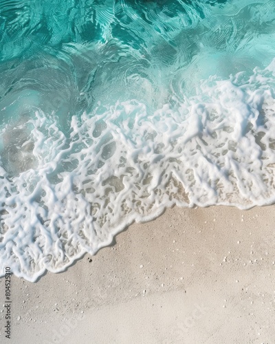 Waves breaking on the sandy beach. Aerial view.