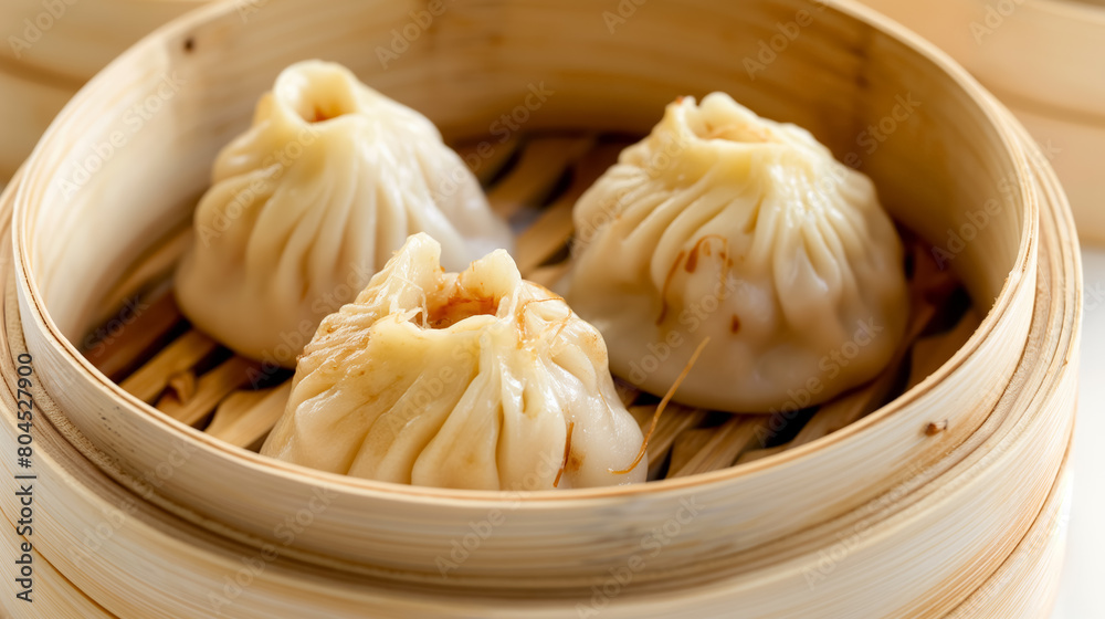 Delicate steamed dumplings in a traditional bamboo steamer, emphasizing the intricate pleating and the steamy, fresh appeal.