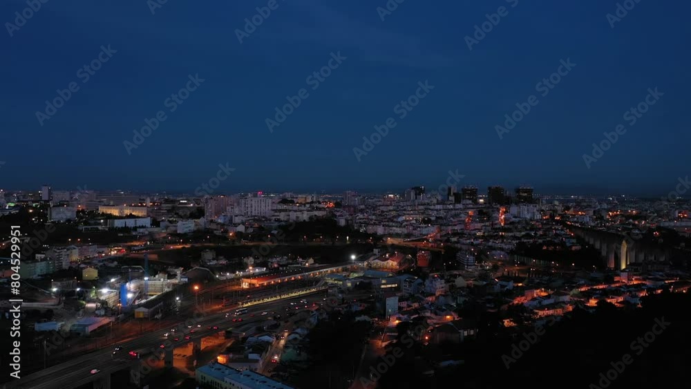Illuminated Lisbon Skyline at Night. Portugal. Aerial View. Drone Moves Upwards Illuminated Lisbon Skyline at Night. Portugal. Aerial View. Drone Moves Upwards