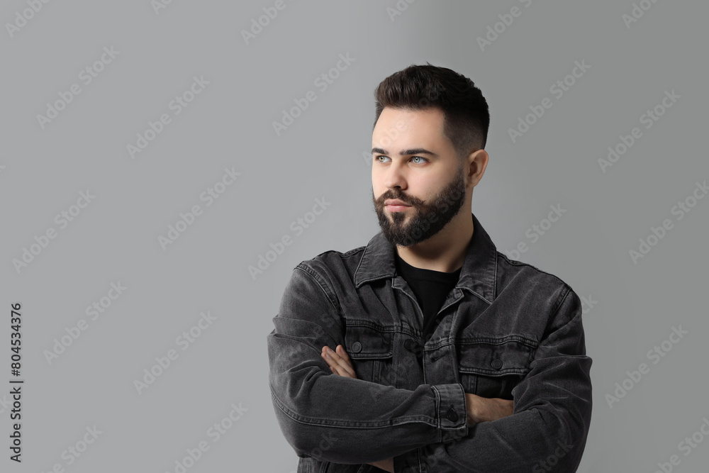Fototapeta premium Portrait of young man with mustache on grey background. Space for text