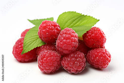 A cluster of ripe raspberries nestled in green foliage on a sunny day, isolated on solid white background.