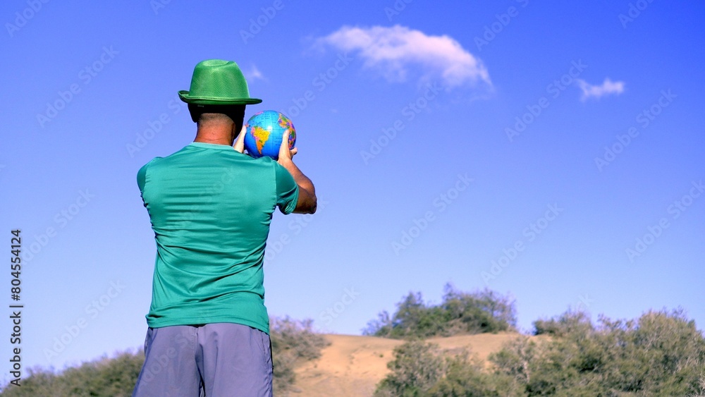 custom made wallpaper toronto digitalA young adult with a globe in his hands observes the arid environment due to global warming. Save planet Earth concepts