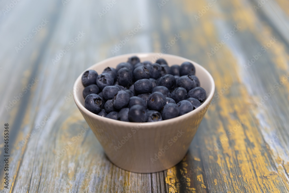 Blueberries isolated on wood table background, close-up, front view, top view, Blueberries isolated on wood table background, close-up, front view, top view,