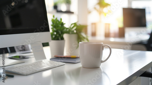 White cup with blurred workspace background © Aku Creative