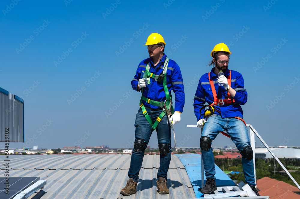Solar roof engineer men working on factory roof 