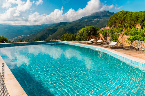 A swimming pool in an idyllic place to spend your summer holidays. © caroxe