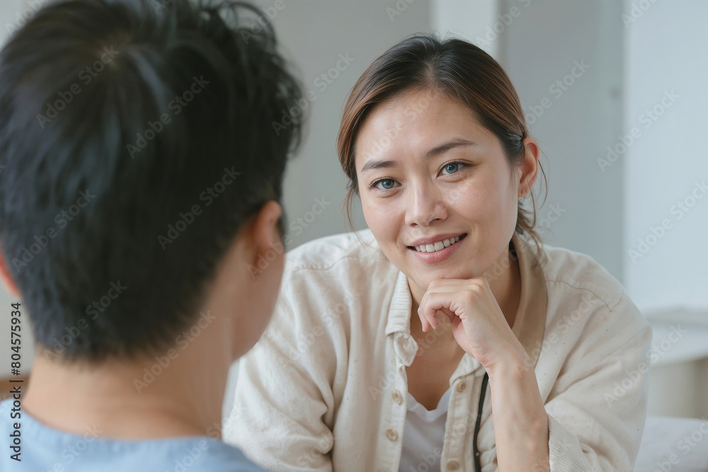 Family psychologist Asian woman talking to a client in private clinic. Asian couple at home sitting in sofa and having a talk Family psychologist Asian woman talking to a client in private clinic. Asian couple at home sitting in sofa and having a talk