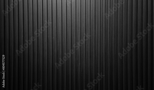vertical dark black wooden slats texture for interior decoration with light from above. black walnut wooden slats in vertical striped line pattern used as background or backdrop. photo