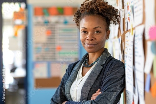 Confident African American female teacher in front of a task board.