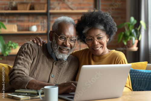 With smiles on their faces, a mature couple enjoys a loving online interaction, participating in a video call together on their laptop, symbolizing the warmth and connection that technology brings to