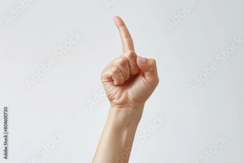 A person's hand with a finger up in the air. Suitable for various concepts and ideas