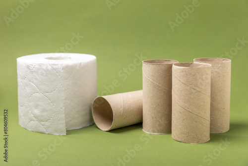 Empty toilet paper roll. Rolls of toilet paper on background. Paper tube of toilet paper. Place for text. Copy space. Flat lay. Eco-friendly reuse recycle