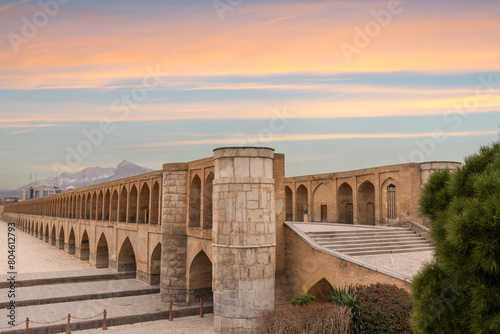 Dusk view of the dry riverbed and 33-arch double-decker bridge (also known as Allahverdi Khan Bridge) in Isfahan, Iran. The bridge has 33 arches and is a typical Safavid-era architecture. photo