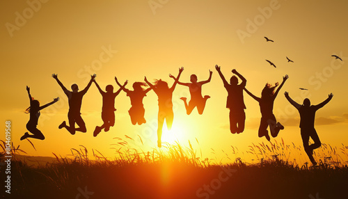 Silhouette of group of successful happy people jumping
