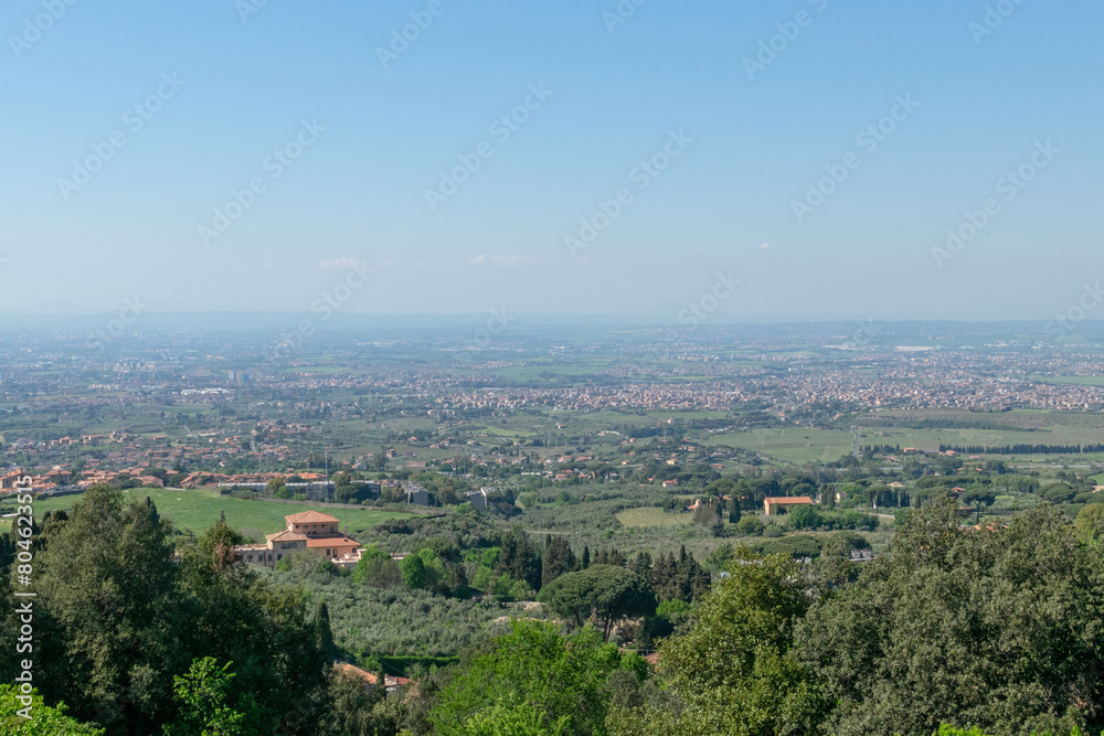 Picturesque panoramic view from the top of the valley in which the suburbs of Rome are located, sunny day, blue sky, distant horizon