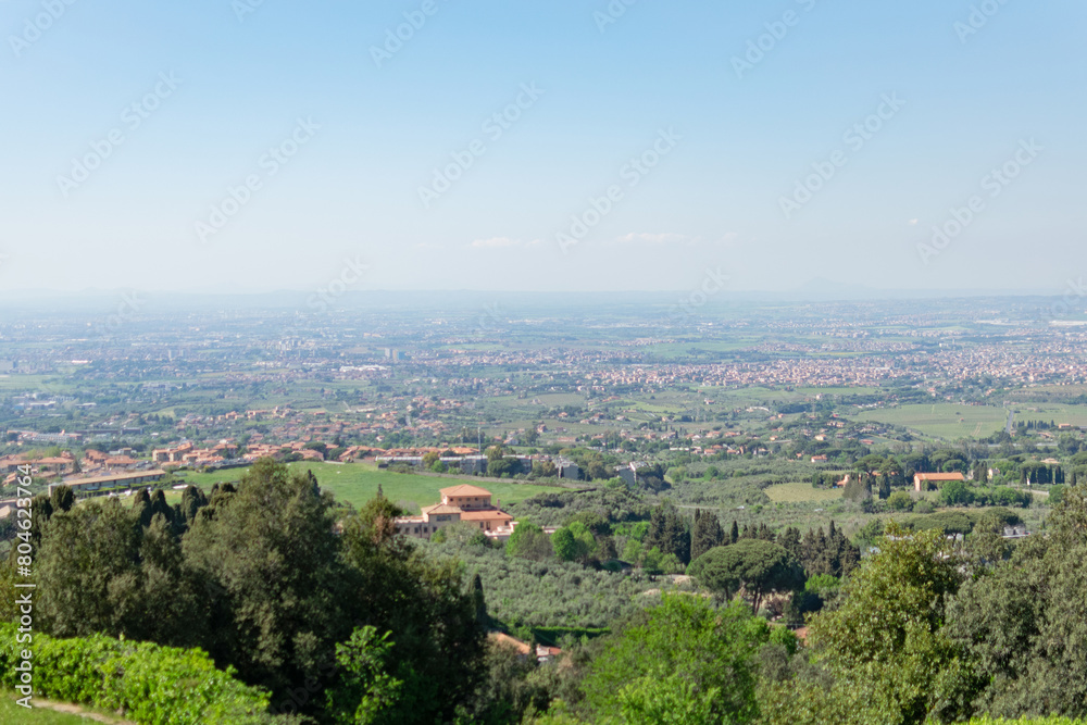 Picturesque panoramic view from the top of the valley in which the suburbs of Rome are located, sunny day, blue sky, distant horizon