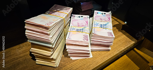 Bales of Turkish Lira banknotes in the bank in front of the cash register photo