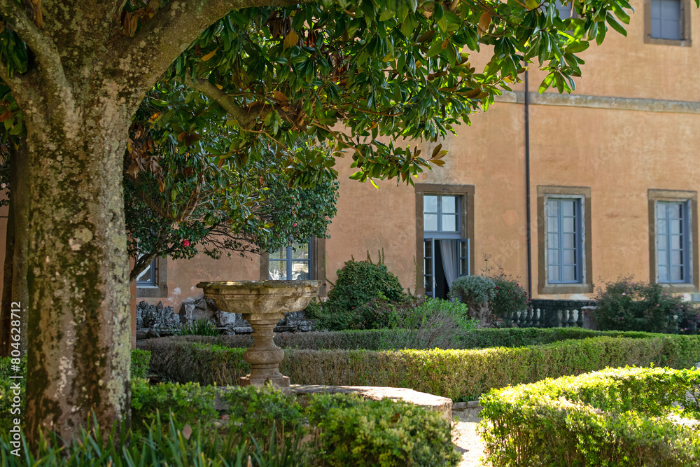 Country old luxury villa - a corner of an elegant garden, topiary bushes