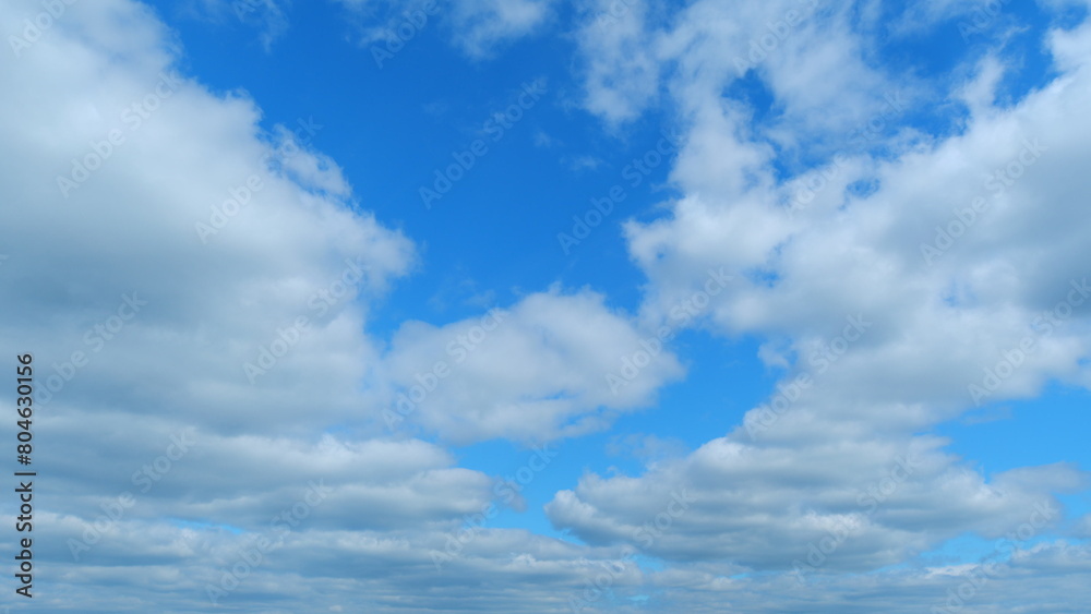 Clouds move in the blue sky. Running clouds against the blue sky. Time lapse.