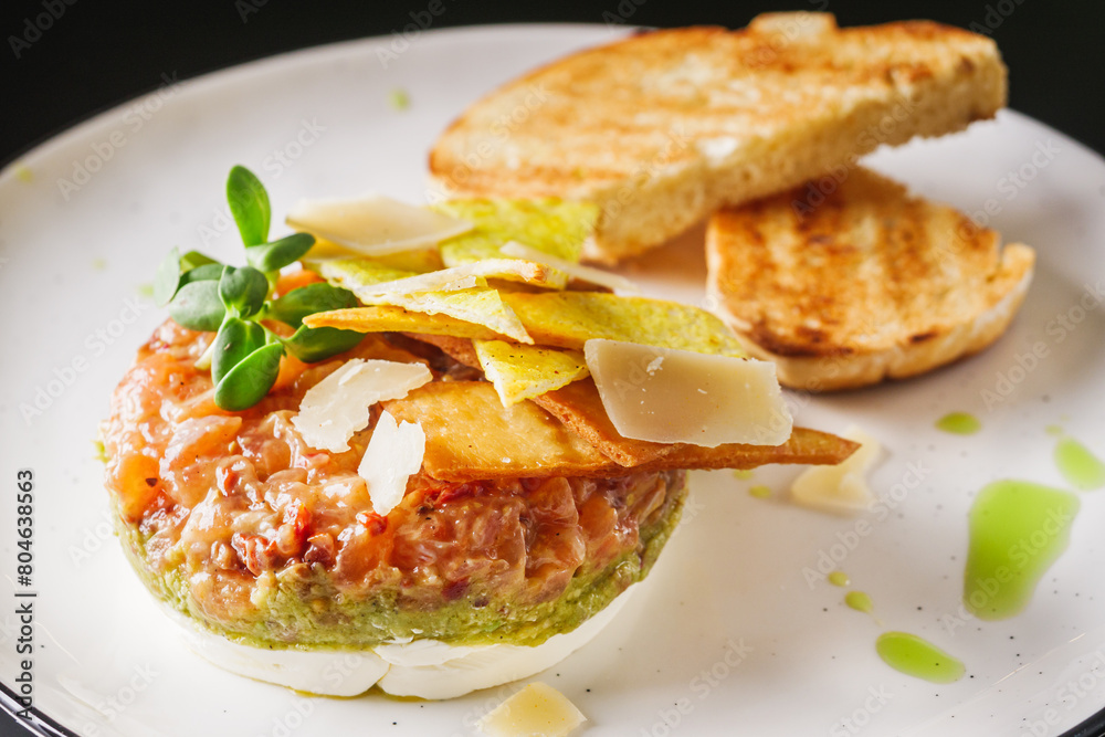 delicious fresh salmon tartar on a white plate delicious fresh salmon tartar on a white plate