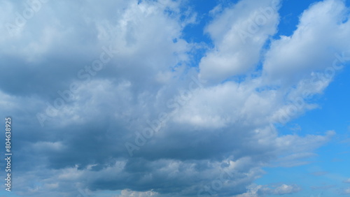 Blue heaven summer cloudscape. Rolling puffy white layered clouds are moving. Time lapse.