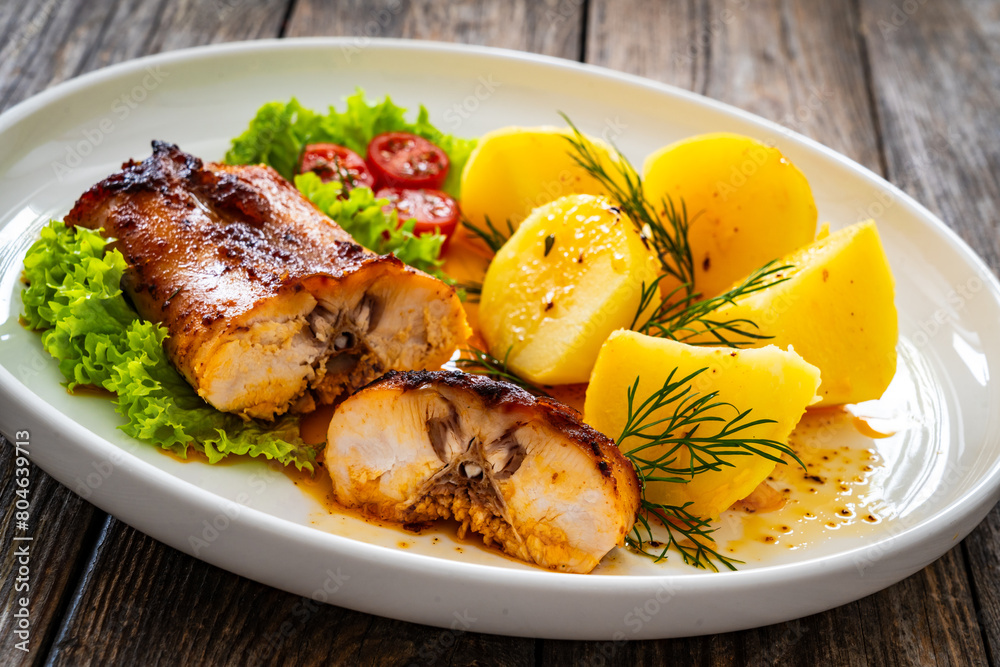Baked rabbit saddle and vegetable salad on wooden table
Baked rabbit saddle and vegetable salad on wooden table