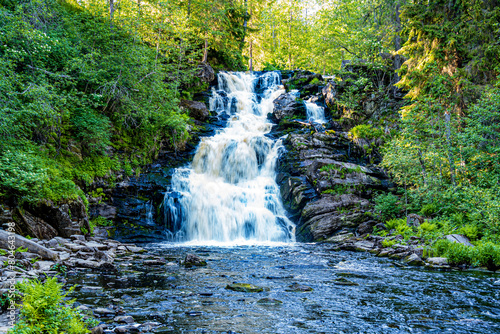 beautiful picturesque strong bubbling waterfall in the ruskeala mountain park in karelia in russia photo