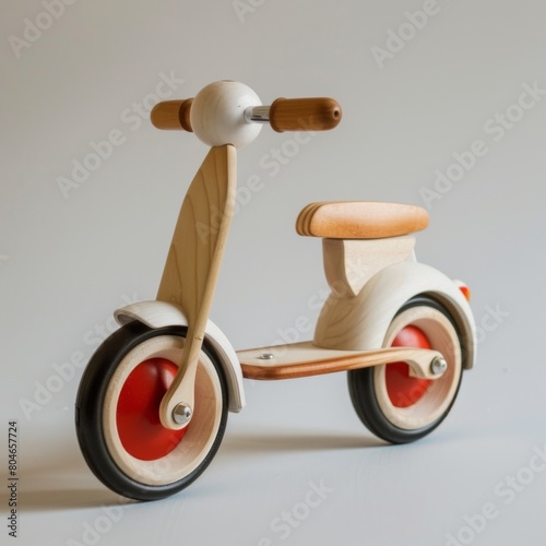 A toy tricycle featuring a charming wooden handlebar photo