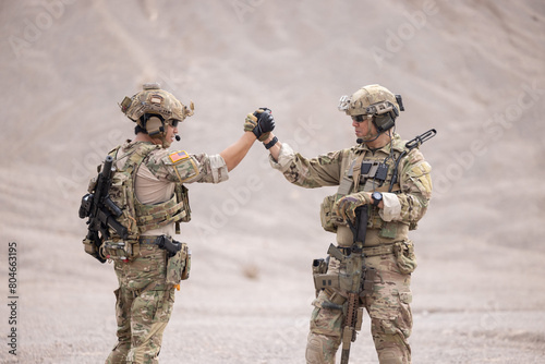 Two soldier greeting together celebrating success