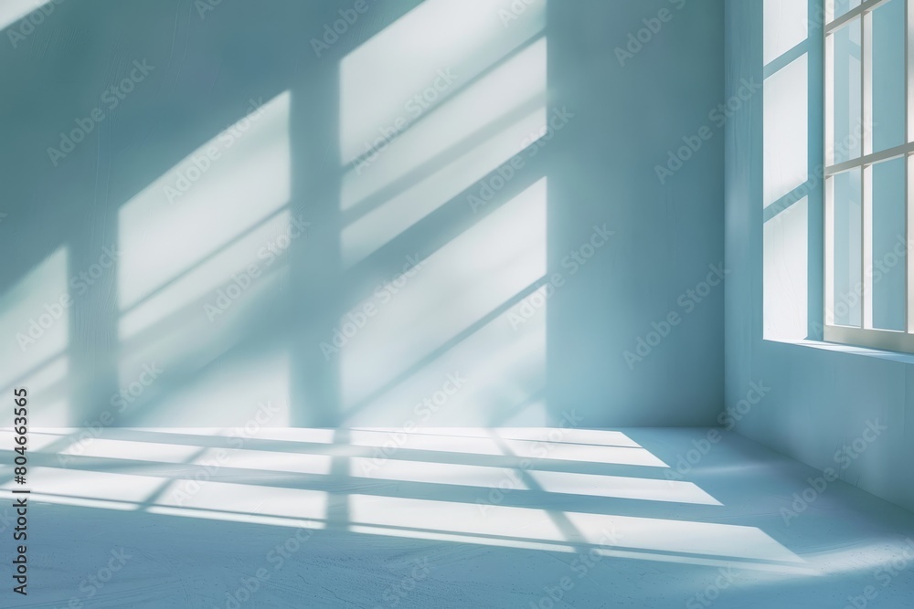 Room with numerous windows, casting shadows on light blue walls. Minimalist design with natural light streaming in Room with numerous windows, casting shadows on light blue walls. Minimalist design with natural light streaming in