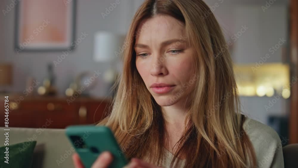 Shocked girl looking mobile phone in home closeup. Woman reading smartphone