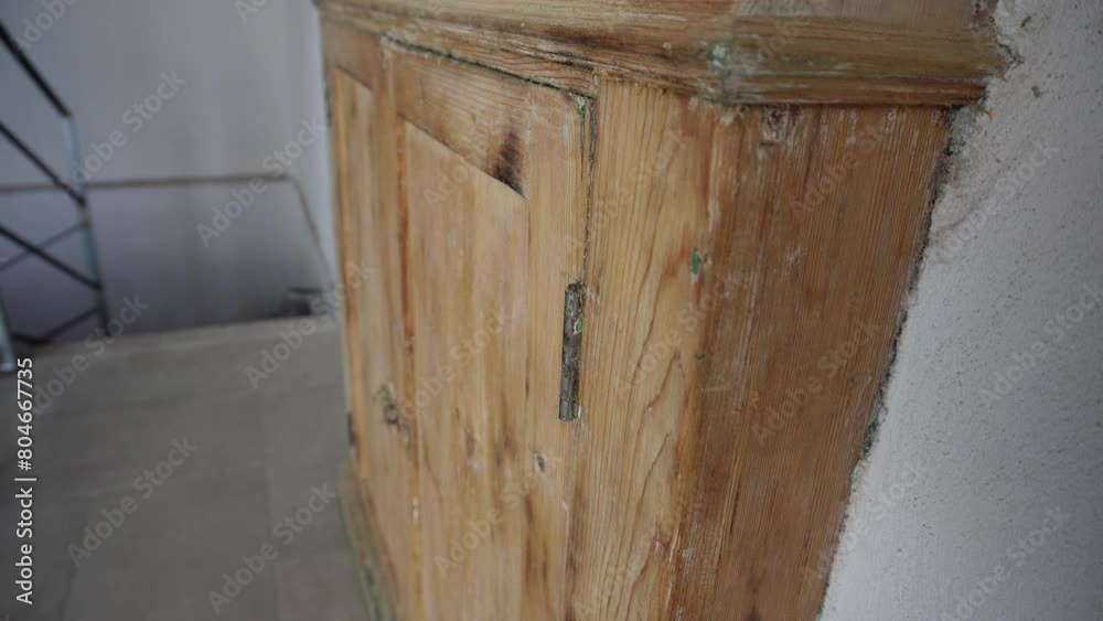 An old wardrobe built into the wall. Italian furniture style. Reusing old things. Close-up process of restoring an old antique cabinet. An old wardrobe built into the wall. Italian furniture style. Reusing old things. Close-up process of restoring an old antique cabinet.