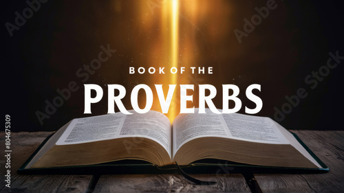 Open Book of Proverbs on a wooden table illuminated from above, creating an atmosphere of inspiration and wisdom photo