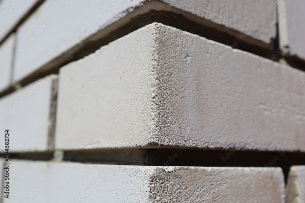 Close-up of a white brick wall from an angle. Brickwork.
