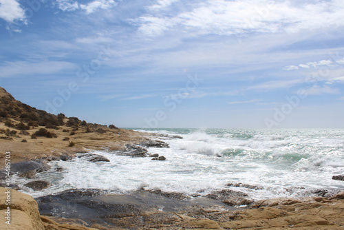 waves on the beach, natural background of sky, sea and rocks, Mediterranean coast in Spain © Iryna